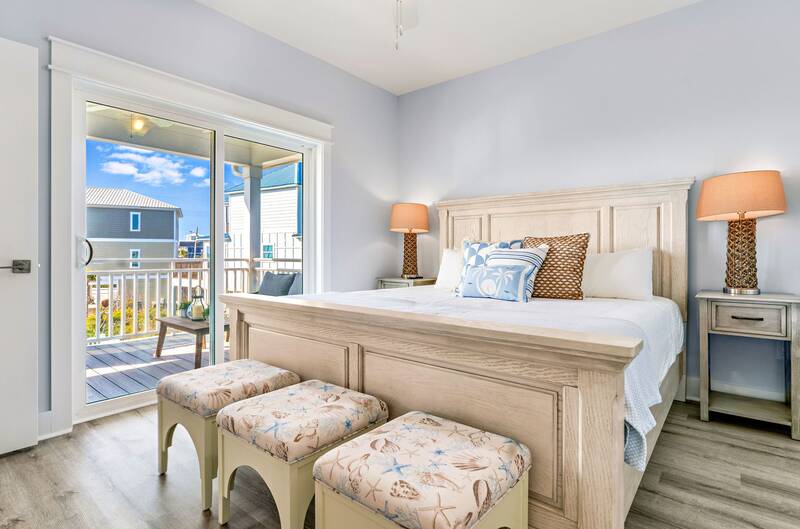 King bedroom with a wooden bed and a door to the deck