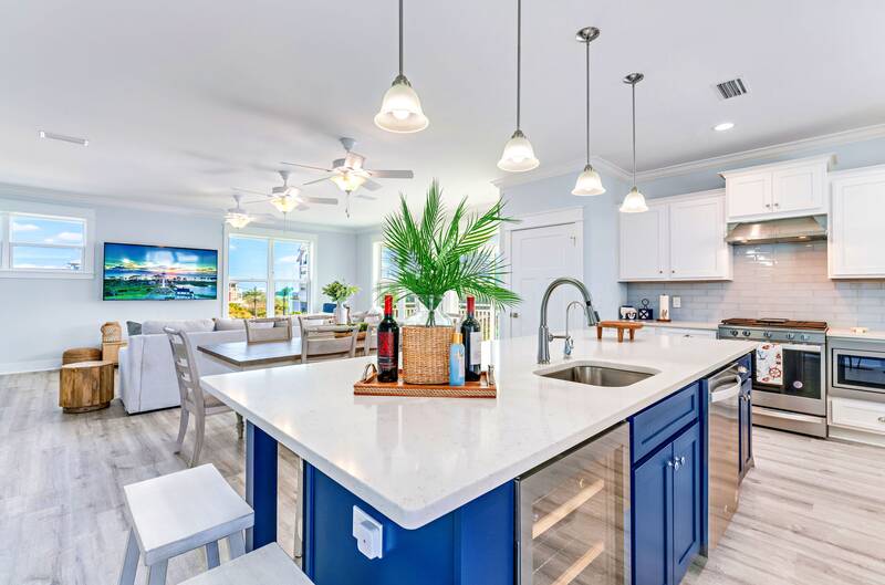 Open kitchen with a blue island and white counters