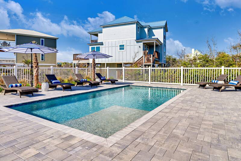 Private pool with loungers and umbrellas on a paved deck